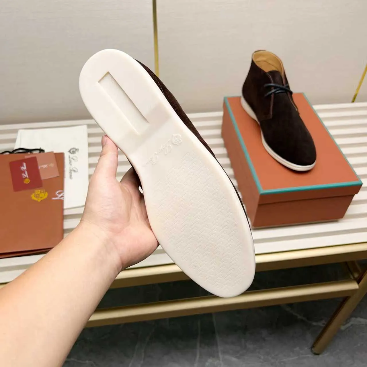 Men's Shoes 💰420 Loro Piana reimagines the desert boot—a modern, comfortable interpretation of a classic 1940s style. Crafted from suede calfskin, it exudes elegance. The tight texture of suede calfskin is not only durable but also looks casual and sophisticated. Add a timeless piece to your shoe collection, harmoniously blending comfort, style and Loro Piana's heritage of craftsmanship. Acetate satin detail on the inside White sole with LP lettering for added traction Space for a personalized signature on the heel Tonal suede trim Upper: 100% cow split suede Sole: 100% Rubber lining: Cow leather